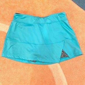 Fila medium light blue/ turquoise tennis skirt with built in shorts.